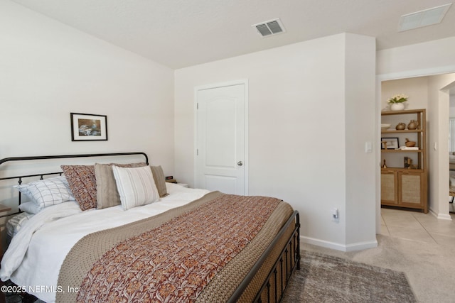 bedroom featuring baseboards, visible vents, and carpet flooring