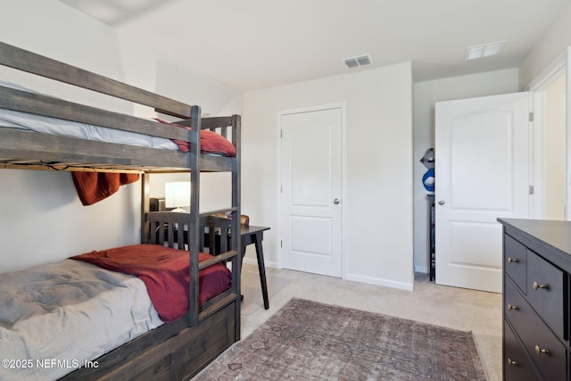 bedroom with light carpet, visible vents, and baseboards