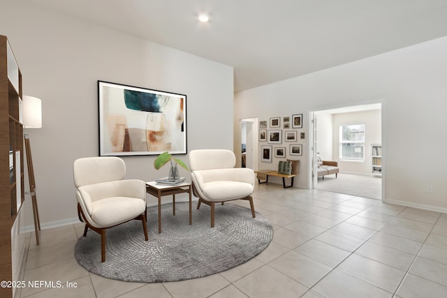 living area with light tile patterned floors and baseboards