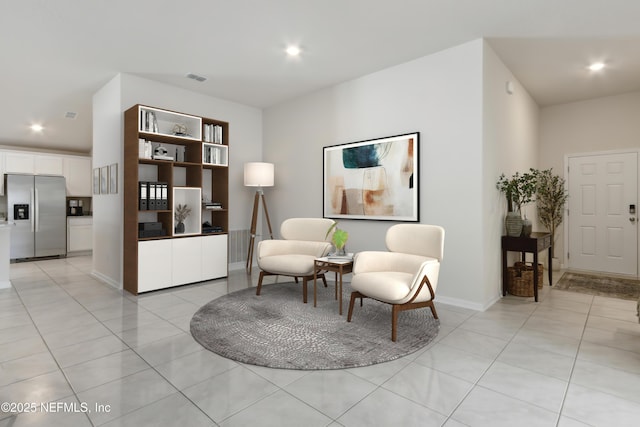 living area with light tile patterned flooring, baseboards, visible vents, and recessed lighting