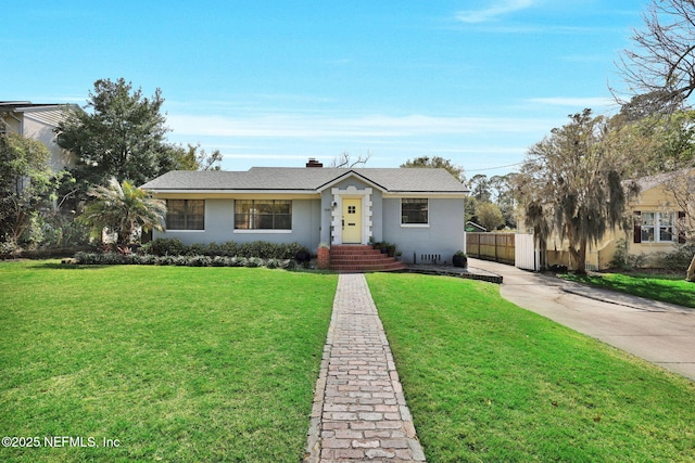 view of front facade with roof with shingles, a chimney, fence, and a front yard