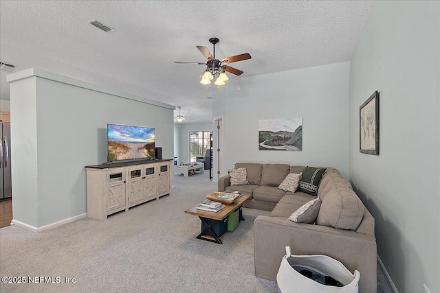 living area featuring a ceiling fan, light colored carpet, and visible vents