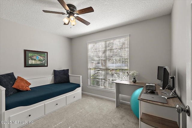 bedroom featuring ceiling fan, a textured ceiling, baseboards, and carpet flooring