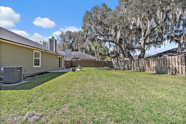 view of yard featuring a patio area, a fenced backyard, and cooling unit