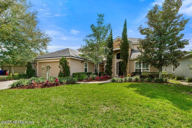 view of front of home featuring a garage, a front lawn, and stucco siding