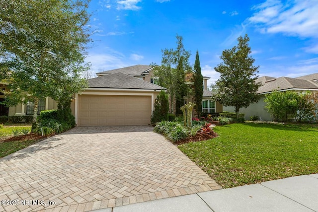 view of front facade featuring decorative driveway, an attached garage, a front lawn, and stucco siding