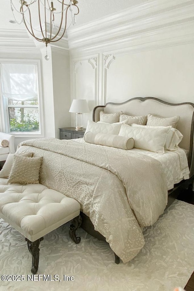 bedroom with crown molding and an inviting chandelier