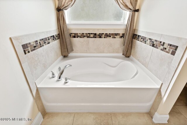 full bathroom with tile patterned flooring and a bath