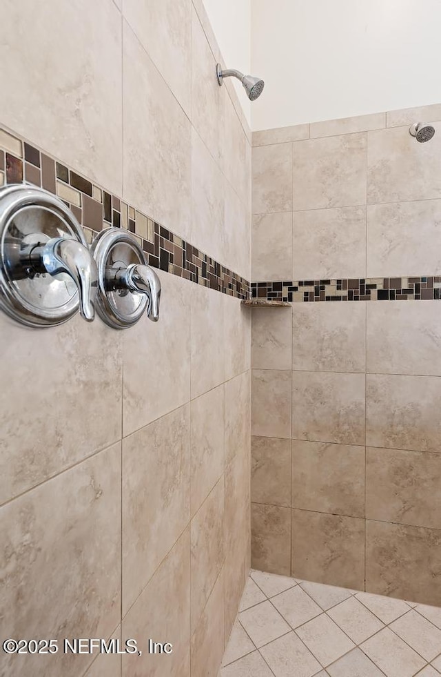 interior details featuring tiled shower