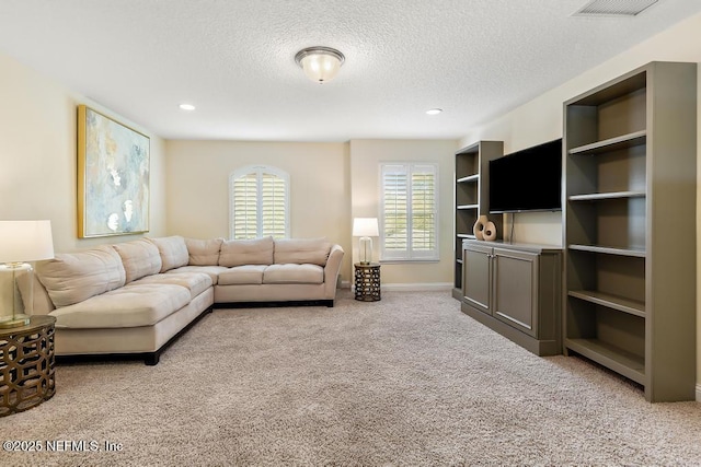 living area featuring recessed lighting, visible vents, light carpet, a textured ceiling, and baseboards