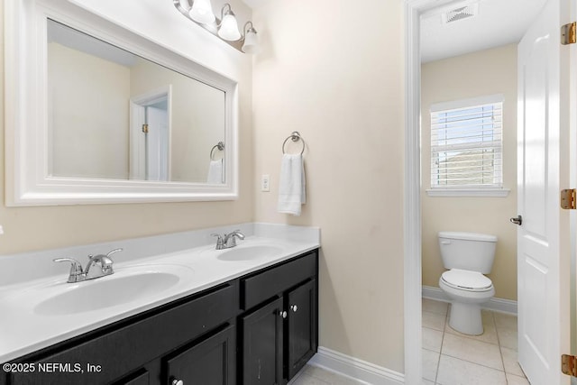 bathroom with double vanity, tile patterned flooring, a sink, and visible vents