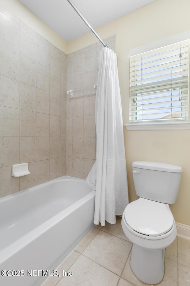 full bathroom with shower / tub combo, toilet, and tile patterned floors