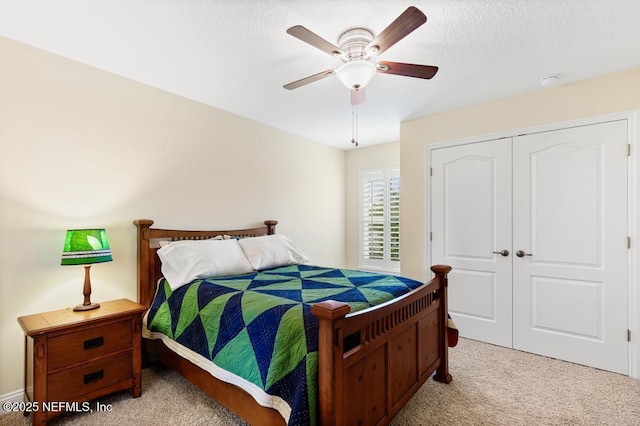 bedroom with a closet, a ceiling fan, and light colored carpet