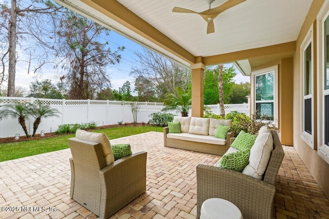 view of patio featuring a ceiling fan, a fenced backyard, and outdoor lounge area