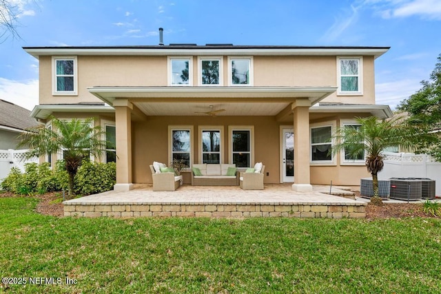 back of house featuring fence, an outdoor living space, a patio, and stucco siding