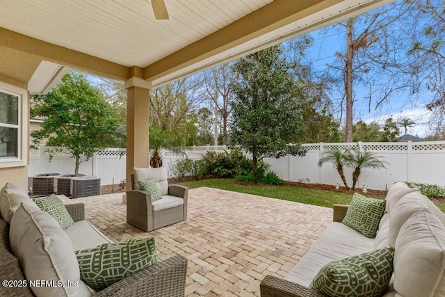 view of patio featuring ceiling fan, outdoor lounge area, and a fenced backyard