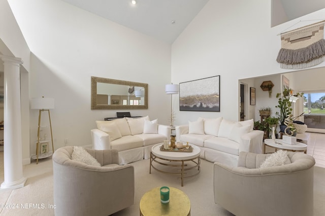 living area with high vaulted ceiling, recessed lighting, and ornate columns