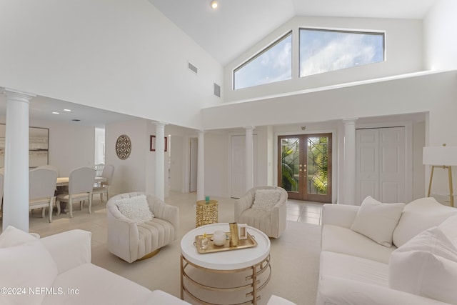 living area with a wealth of natural light, french doors, and decorative columns