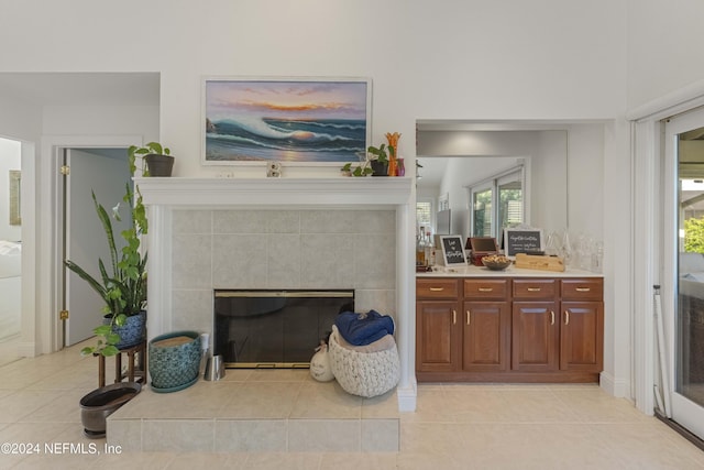 interior space with a tile fireplace