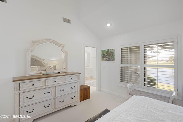 bedroom featuring light colored carpet, visible vents, vaulted ceiling, ensuite bath, and baseboards