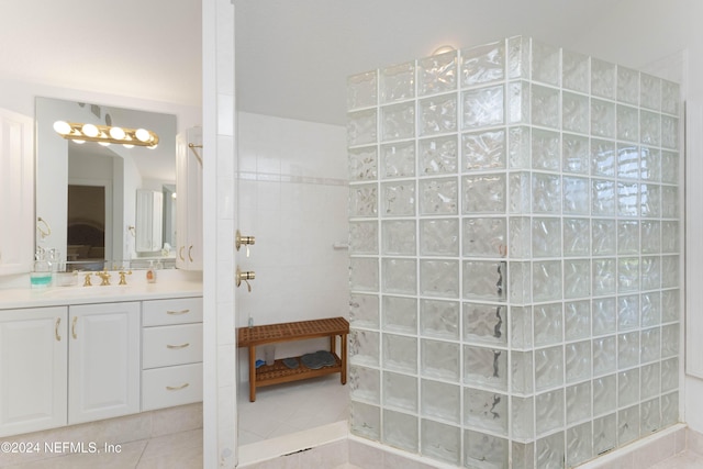 ensuite bathroom with ensuite bath, tile patterned flooring, walk in shower, and vanity