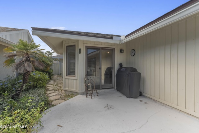 entrance to property featuring a patio area and fence