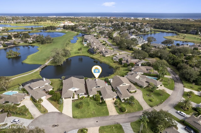 bird's eye view featuring a residential view and a water view