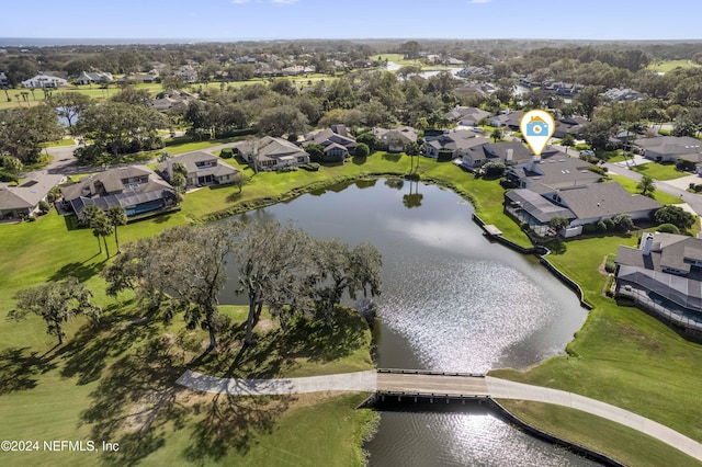 drone / aerial view with a water view and a residential view