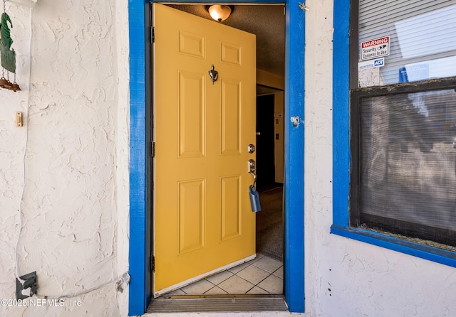 view of exterior entry with stucco siding