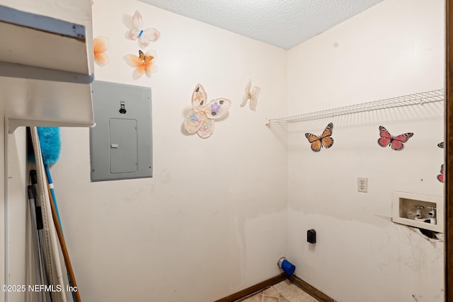 washroom featuring hookup for a washing machine, a textured ceiling, laundry area, electric panel, and baseboards