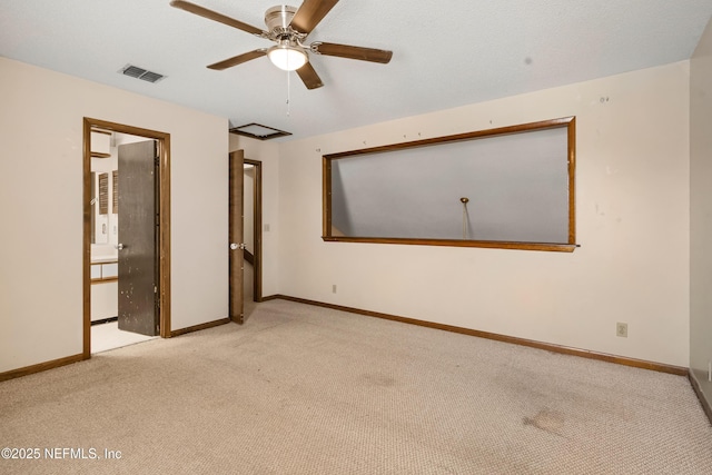 carpeted empty room with baseboards, visible vents, and ceiling fan