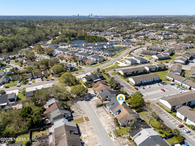 drone / aerial view with a water view and a residential view