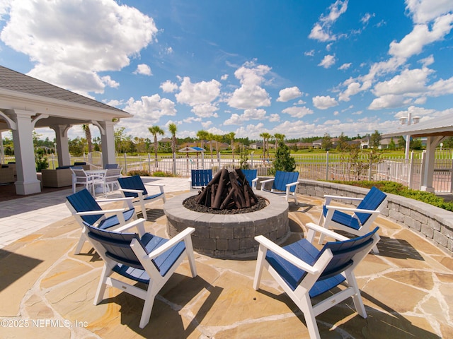 view of patio featuring a gazebo, a fire pit, and fence