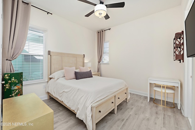 bedroom with baseboards, light wood-style flooring, and a ceiling fan