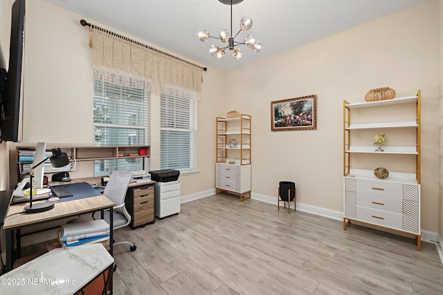 home office featuring light wood finished floors, a notable chandelier, and baseboards