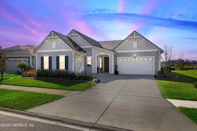 view of front of property featuring a garage, a lawn, board and batten siding, and concrete driveway