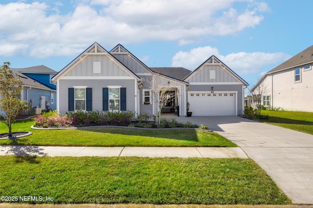 view of front facade featuring board and batten siding, an attached garage, a front yard, and concrete driveway