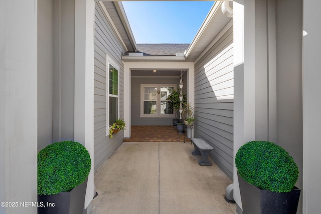 entrance to property with roof with shingles