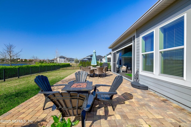 view of patio / terrace with outdoor dining area, a residential view, a fenced backyard, and an outdoor fire pit