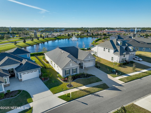 drone / aerial view featuring a residential view and a water view