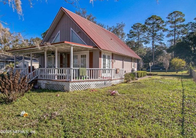 view of front facade featuring metal roof, french doors, a front yard, and a ceiling fan