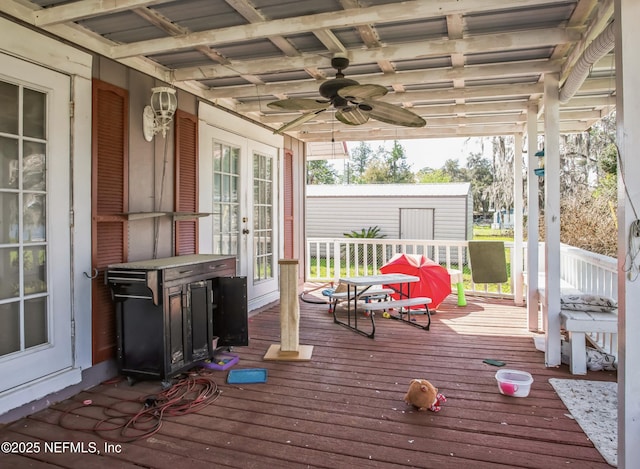 wooden deck with ceiling fan and french doors