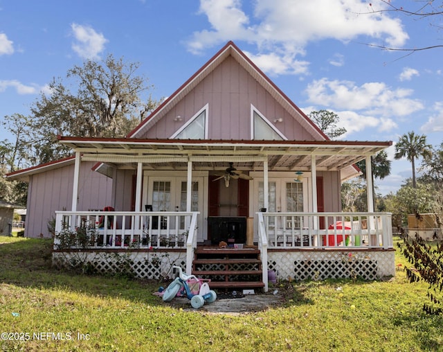 view of front of home featuring covered porch, a front lawn, a ceiling fan, and french doors