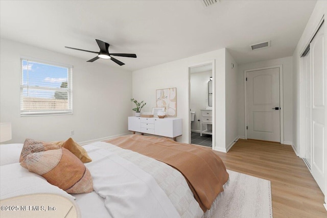 bedroom featuring a closet, visible vents, light wood-style floors, ceiling fan, and baseboards