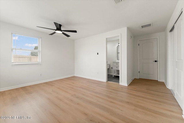 unfurnished bedroom with visible vents, baseboards, connected bathroom, light wood-style flooring, and a closet