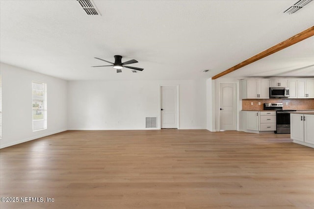 unfurnished living room featuring light wood-type flooring and visible vents