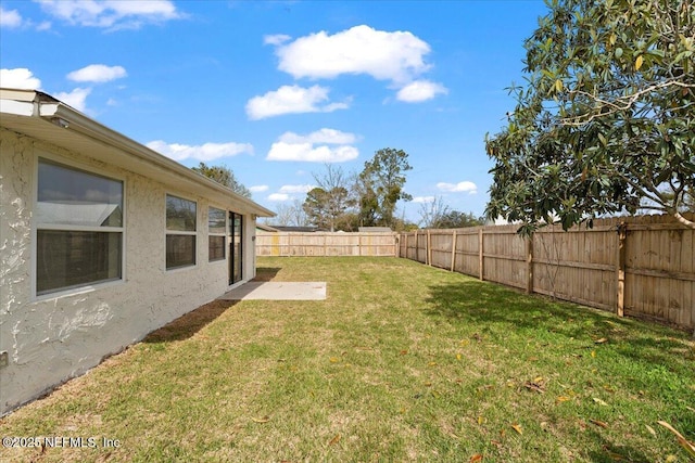 view of yard with a fenced backyard