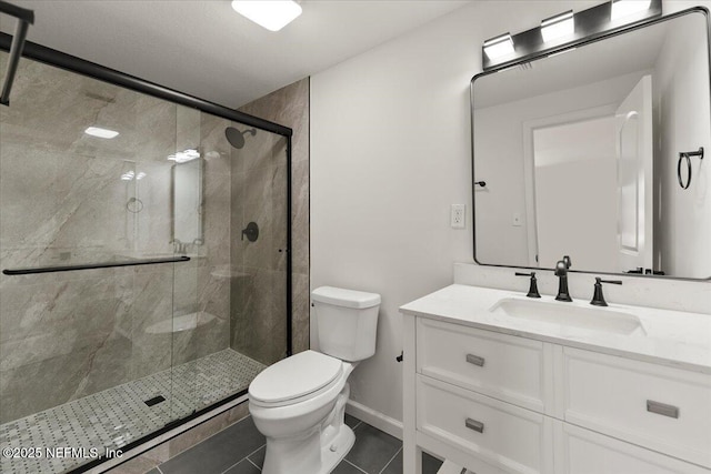 full bathroom featuring baseboards, toilet, tile patterned flooring, vanity, and a shower stall