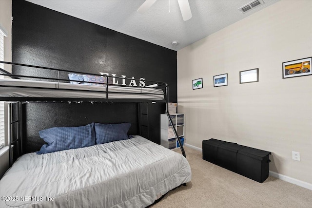 bedroom with carpet flooring, baseboards, visible vents, and a textured ceiling