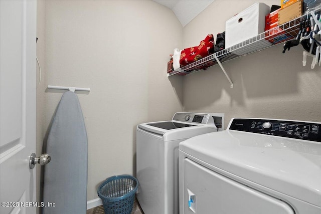 clothes washing area featuring independent washer and dryer and laundry area